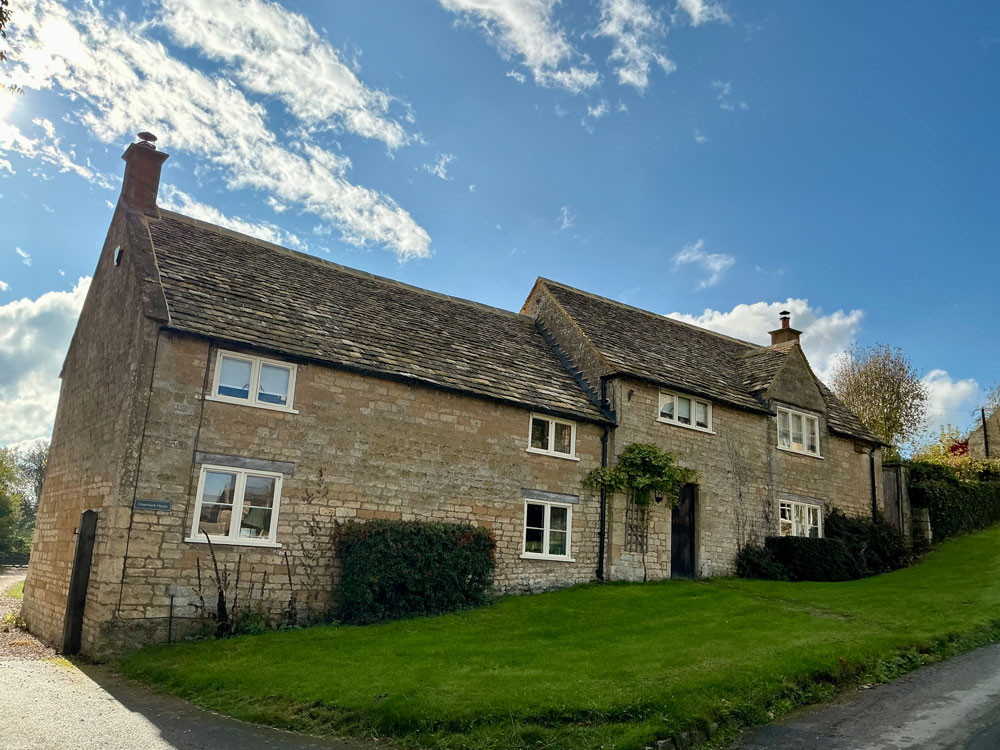 Stone village house with a new Cotswold stone slate roof