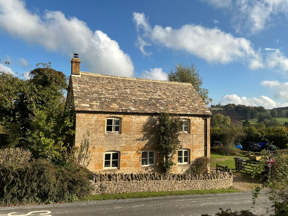 Detached countryside cottage with a new Cotswold stone slate roof